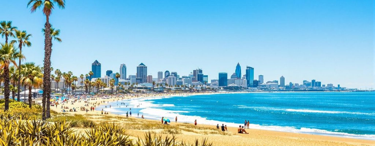 San Diego beach with skyline and palm trees.