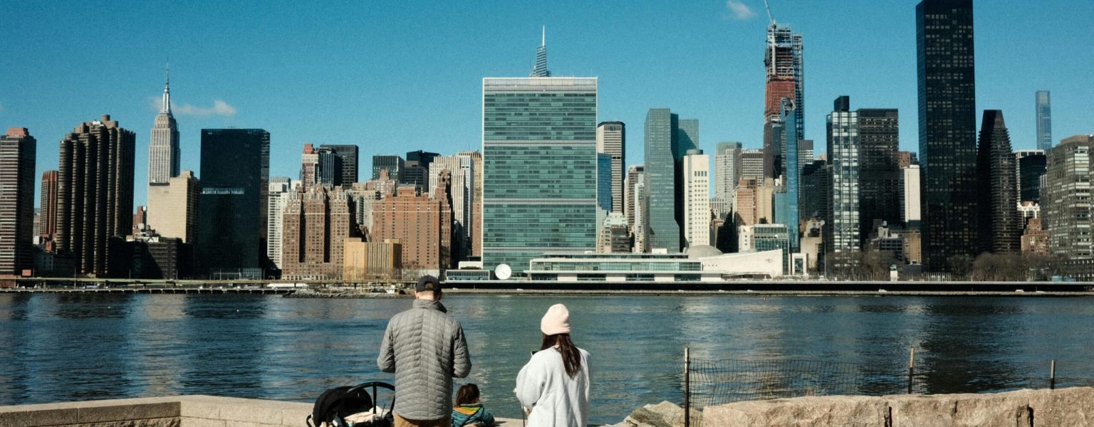 Family Looking at Skyscrapers in Skyline of New York City in USA